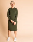 Woman wearing soft Australian Merino wool relaxed fitting long sleeve crew neck dress in hunter green. Designed as a relaxed fit and sitting around knee length. This style is perfect as a base to add other layers. Made in Australia at Woolerina's workrooms at Forbes in central west NSW.