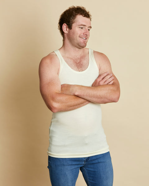 Man wearing soft Australia Merino wool sleeveless singlet in natural. Designed to wear next to the skin as a base layer/thermal style, under other layers. Made in Australia at Woolerina's workrooms at Forbes in central west NSW.