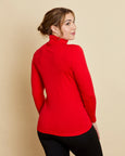 Woman wearing soft Australian Merino wool long sleeve turtleneck in tomato red. Designed to wear next to the skin as a base layer and also perfect for layering. Made in Australia at Woolerina's workrooms at Forbes in central west NSW.