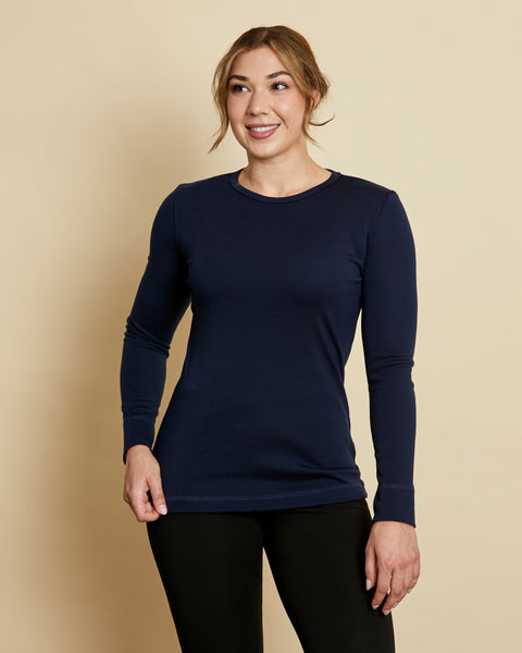 Woman wearing soft Australian Merino wool long sleeve crew neck in navy. Designed to wear next to the skin either as a base layer or as a t.shirt style on its own. This style is perfect for layering. Made in Australia at Woolerina's workrooms at Forbes in central west NSW.