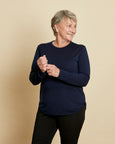 Woman wearing soft Australian Merino wool crew neck pullover in navy. Relaxed fitting, designed to wear over other layers as an outer layer or on its own next to the skin. Made in Australia at Woolerina's workrooms at Forbes in central west NSW.