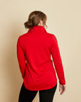 Woman wearing a soft Australian Merino wool pullover with a quarter zip in tomato red. Relaxed fitting, designed to wear over other layers as an outer layer or on its own next to the skin. Made in Australia at Woolerina's workroom at Forbes in central west NSW.