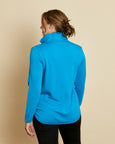 Woman wearing a soft Australian Merino wool pullover with a quarter zip in turquoise. Relaxed fitting, designed to wear over other layers as an outer layer or on its own next to the skin. Made in Australia at Woolerina's workroom at Forbes in central west NSW.