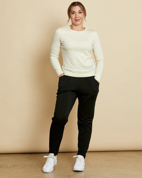 Woman wearing soft Australian Merino wool lightweight, relaxed fitting "happy pant" in black. relaxed fitting around the hips, tapering in at the ankle and with pockets and an elastic waist. Made in Australia at Woolerina's workrooms at Forbes in central west NSW.