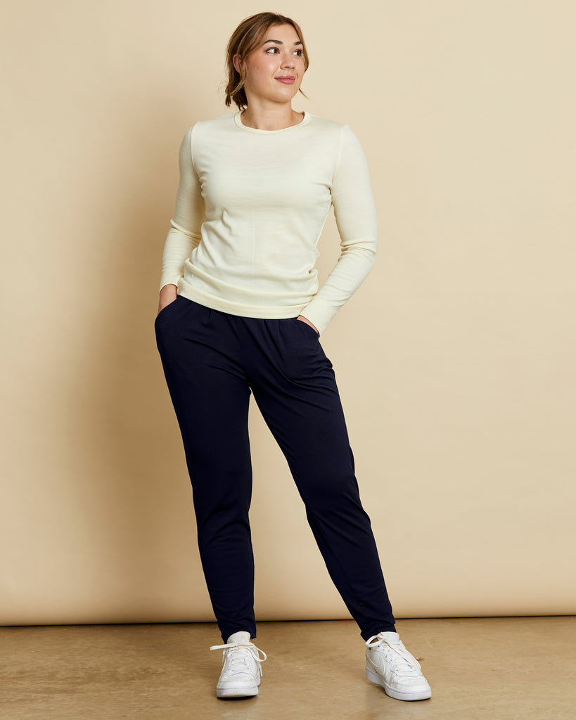 Woman wearing soft Australian Merino wool lightweight, relaxed fitting "happy pant" in navy. relaxed fitting around the hips, tapering in at the ankle and with pockets and an elastic waist. Made in Australia at Woolerina's workrooms at Forbes in central west NSW.