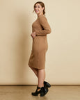 Woman wearing soft Australian Merino wool relaxed fitting long sleeve crew neck dress in camel. Designed as a relaxed fit and sitting around knee length. This style is perfect as a base to add other layers. Made in Australia at Woolerina's workrooms at Forbes in central west NSW.