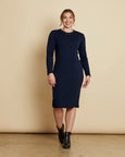 Woman wearing soft Australian Merino wool relaxed fitting long sleeve crew neck dress in navy. Designed as a relaxed fit and sitting around knee length. This style is perfect as a base to add other layers. Made in Australia at Woolerina's workrooms at Forbes in central west NSW.