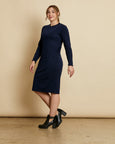 Woman wearing soft Australian Merino wool relaxed fitting long sleeve crew neck dress in navy. Designed as a relaxed fit and sitting around knee length. This style is perfect as a base to add other layers. Made in Australia at Woolerina's workrooms at Forbes in central west NSW.