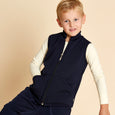 Boy wearing soft Australian Merino wool full zip sleeveless vest in navy. Designed to wear over other layers as an outer layer. Made in Australia at Woolerina's workrooms at Forbes in central west NSW.