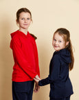 Children wearing soft Australian Merino wool hoodies in red and navy. Designed to wear over other layers as an outer layer. Made in Australia at Woolerina's workrooms at Forbes in central west NSW.