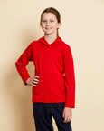 Girl wearing soft Australian Merino wool hoodie in red. Designed to wear over other layers as an outer layer. Made in Australia at Woolerina's workrooms at Forbes in central west NSW.