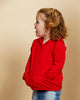 Girl wearing soft Australian Merino wool hoodie in red. Designed to wear over other layers as an outer layer. Made in Australia at Woolerina's workrooms at Forbes in central west NSW.