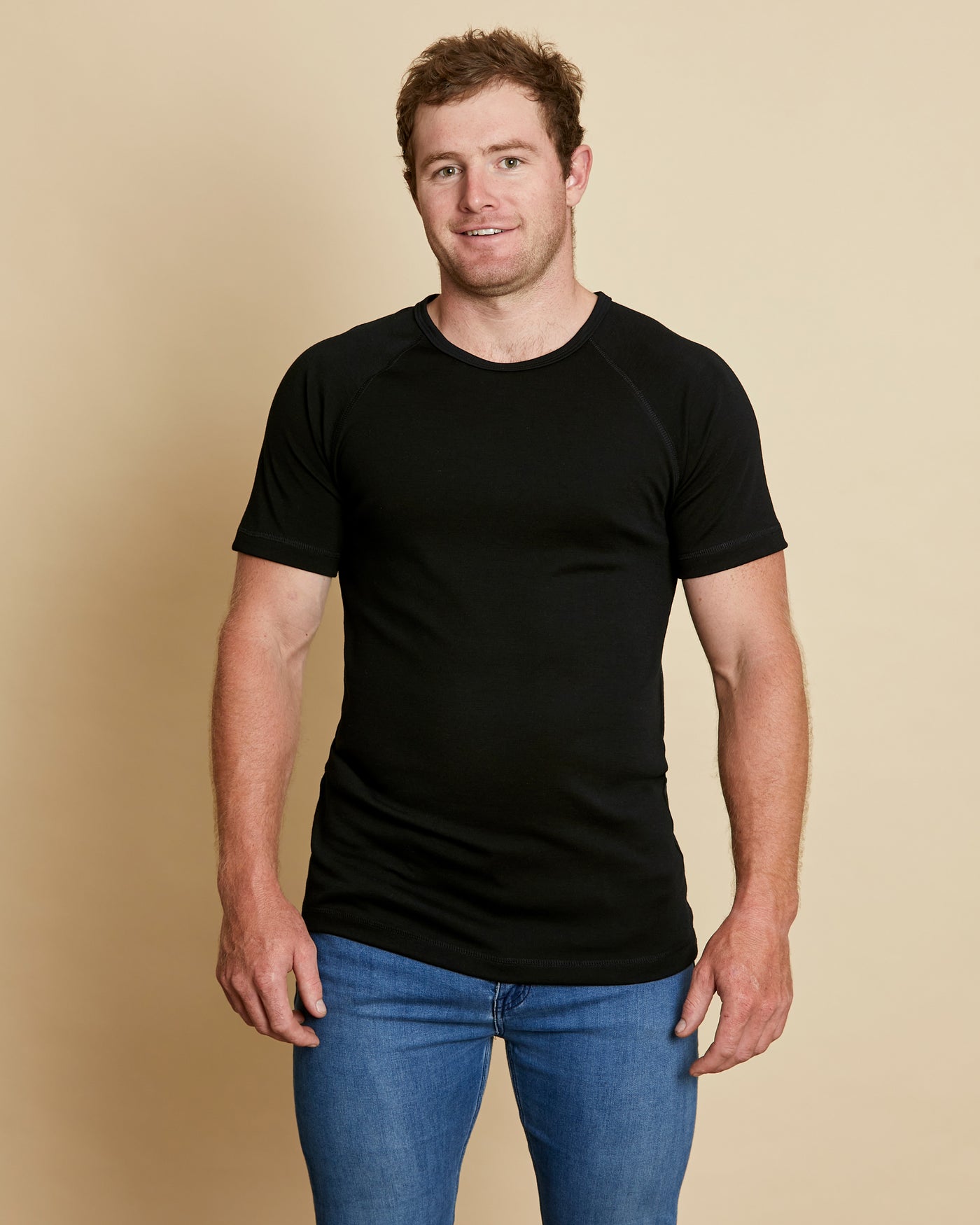 Man wearing soft Australian Merino wool short sleeve crew neck t.shirt in black. Designed to wear next to the skin as a base layer or on its own as a t.shirt style. Made in Australia at Woolerina's workrooms at Forbes in central west NSW.