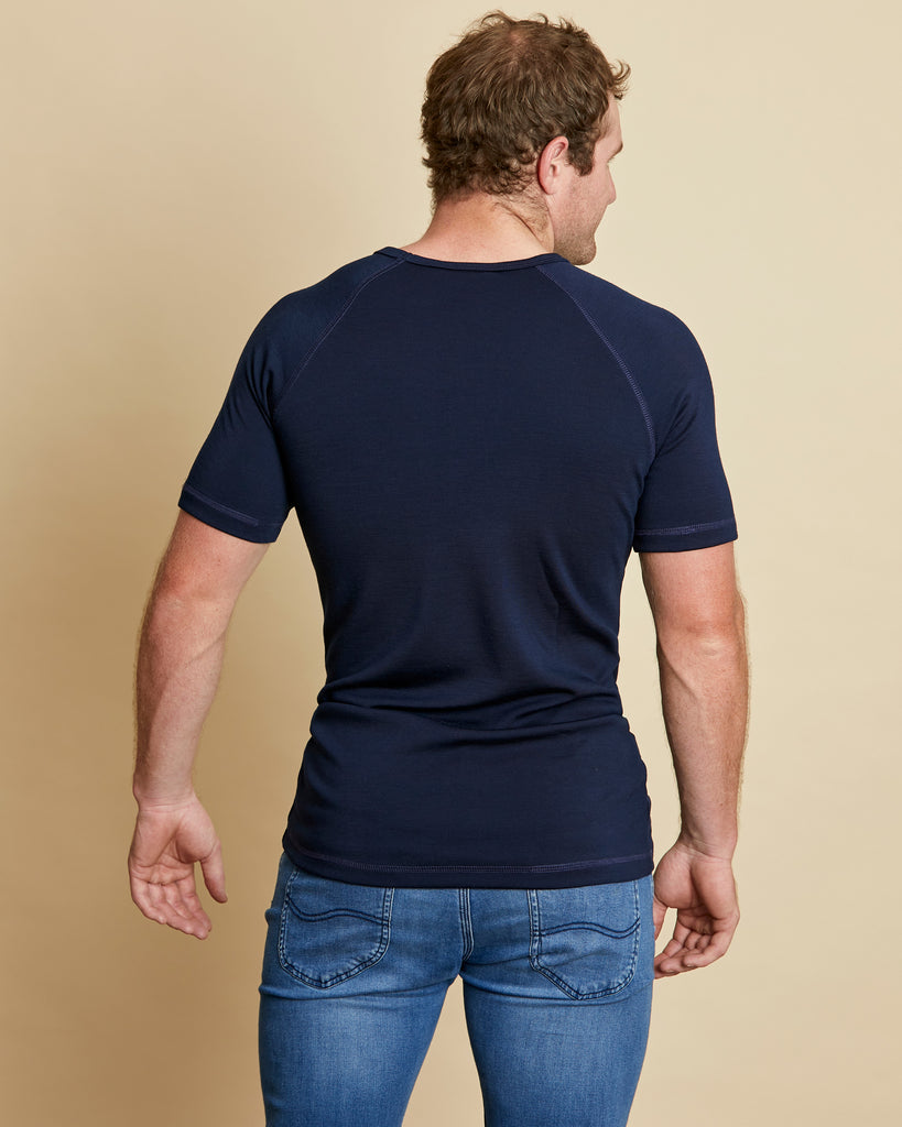 Man wearing soft Australian Merino wool short sleeve crew neck t.shirt in navy. Designed to wear next to the skin as a base layer or on its own as a t.shirt style. Made in Australia at Woolerina's workrooms at Forbes in central west NSW.