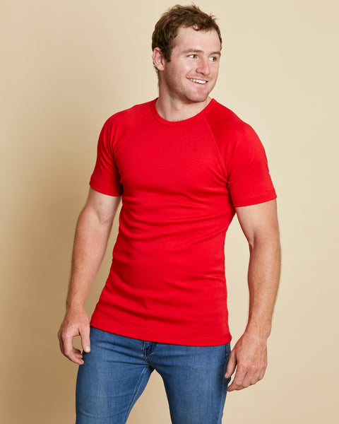 Man wearing soft Australia Merino wool short sleeve crew neck t.shirt in tomato red. Designed to wear next to the skin as a base layer/thermal or on its own as a t.shirt style. Made in Australia at Woolerina's workrooms at Forbes in central west NSW.