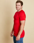 Man wearing soft Australia Merino wool short sleeve crew t.shirt in tomato red. Designed to wear next to the skin as a base layer/thermal or on its own as a t.shirt style. Made in Australia at Woolerina's workrooms at Forbes in central west NSW.
