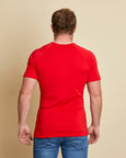 Man wearing soft Australia Merino wool short sleeve crew neck t.shirt in tomato red. Designed to wear next to the skin as a base layer/thermal or on its own as a t.shirt style. Made in Australia at Woolerina's workrooms at Forbes in central west NSW.