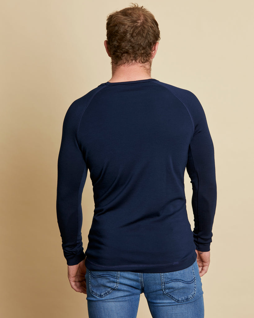 Man wearing soft Australian Merino Wool long sleeve t.shirt in navy. Designed to be worn next to the skin either as a base layer/thermal style or as a t.shirt on its own. Australian Made at Woolerina's workrooms at Forbes in central west NSW.
