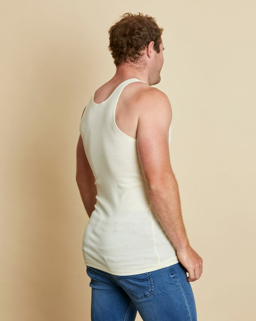 Man wearing soft Australia Merino wool sleeveless singlet in natural. Designed to wear next to the skin as a base layer/thermal style, under other layers. Made in Australia at Woolerina's workrooms at Forbes in central west NSW.