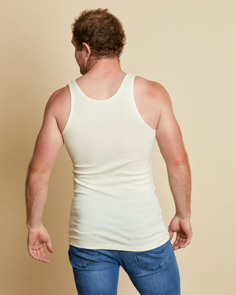 Man wearing soft Australia Merino wool sleeveless singlet in natural. Designed to wear next to the skin as a base layer/thermal style, under other layers. Made in Australia at Woolerina's workrooms at Forbes in central west NSW.
