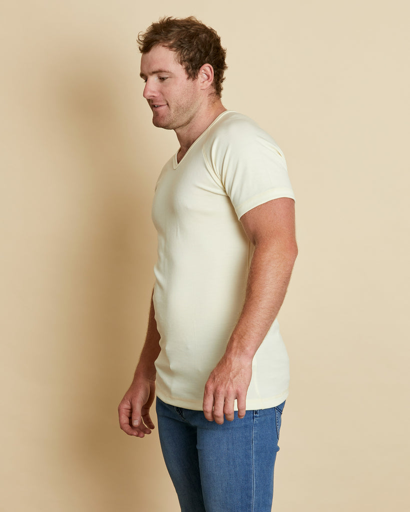 Man wearing soft Australia Merino wool short sleeve V neck t.shirt in natural. Designed to wear next to the skin as a base layer/thermal or on its own as a t.shirt style. Made in Australia at Woolerina's workrooms at Forbes in central west NSW.