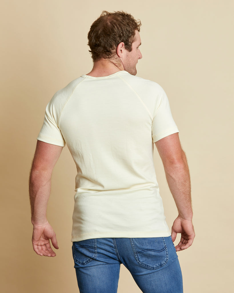 Man wearing soft Australia Merino wool short sleeve V neck t.shirt in natural. Designed to wear next to the skin as a base layer/thermal or on its own as a t.shirt style. Made in Australia at Woolerina's workrooms at Forbes in central west NSW.