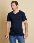 Man wearing soft Australia Merino wool short sleeve V neck t.shirt in navy. Designed to wear next to the skin as a base layer/thermal or on its own as a t.shirt style. Made in Australia at Woolerina's workrooms at Forbes in central west NSW.