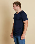 Man wearing soft Australia Merino wool short sleeve V neck t.shirt in navy. Designed to wear next to the skin as a base layer/thermal or on its own as a t.shirt style. Made in Australia at Woolerina's workrooms at Forbes in central west NSW.