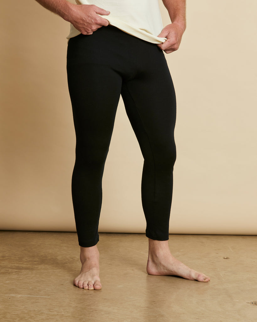 Man wearing a pair of soft Australian Merino wool longjohns in black. These can be worn under other layers. Made in Australia at Woolerina's workroom at Forbes in central west NSW.