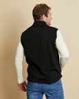 Man wearing a soft Australian Merino wool full zip vest in black. Designed to wear over other layers as an outer layer. Made in Australia at Woolerina's workrooms at Forbes in central west NSW.