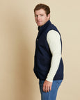 Man wearing a soft Australian Merino wool full zip vest in navy. Designed to wear over other layers as an outer layer. Made in Australia at Woolerina's workrooms at Forbes in central west NSW.