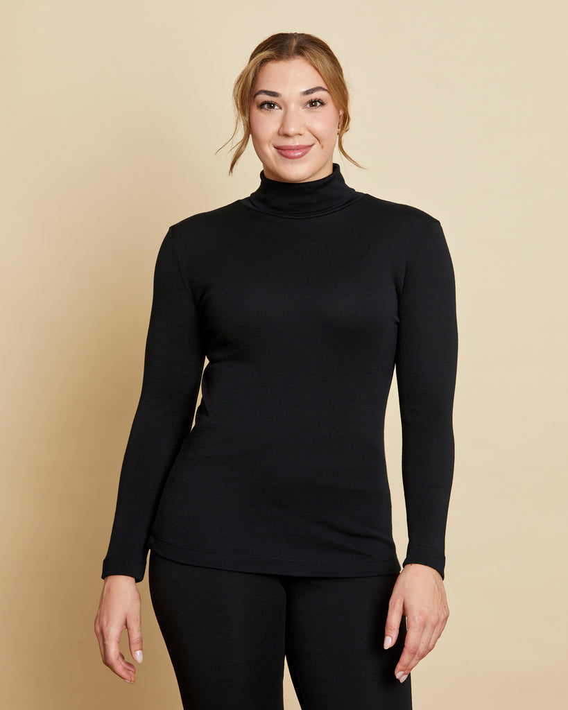 Woman wearing soft Australian Merino wool long sleeve turtleneck in black. Designed to wear next to the skin as a base layer and also perfect for layering. Made in Australia at Woolerina's workrooms at Forbes in central west NSW.