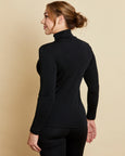 Woman wearing soft Australian Merino wool long sleeve turtleneck in black. Designed to wear next to the skin as a base layer and also perfect for layering. Made in Australia at Woolerina's workrooms at Forbes in central west NSW.