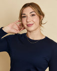Woman wearing soft Australian Merino wool long sleeve crew neck in navy. Designed to wear next to the skin either as a base layer or as a t.shirt style on its own. This style is perfect for layering. Made in Australia at Woolerina's workrooms at Forbes in central west NSW.
