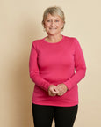Woman wearing soft Australian Merino wool long sleeve crew neck in hot pink. Designed to wear next to the skin either as a base layer or as a t.shirt style on its own. This style is perfect for layering. Made in Australia at Woolerina's workrooms at Forbes in central west NSW.
