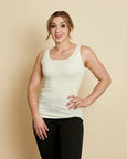 Woman wearing soft Australian Merino wool sleeveless singlet in natural. Designed to wear next to the skin as a base layer, it is perfect for layering. Made in Australian at Woolerina's workrooms at Forbes in central west NSW.