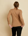 Woman wearing soft Australian Merino wool long sleeve scoop neck in camel. Designed to wear next to the skin as a base layer or on its own as a t.shirt style, it is perfect for layering! Made in Australia at Woolerina workrooms at Forbes in central west NSW.