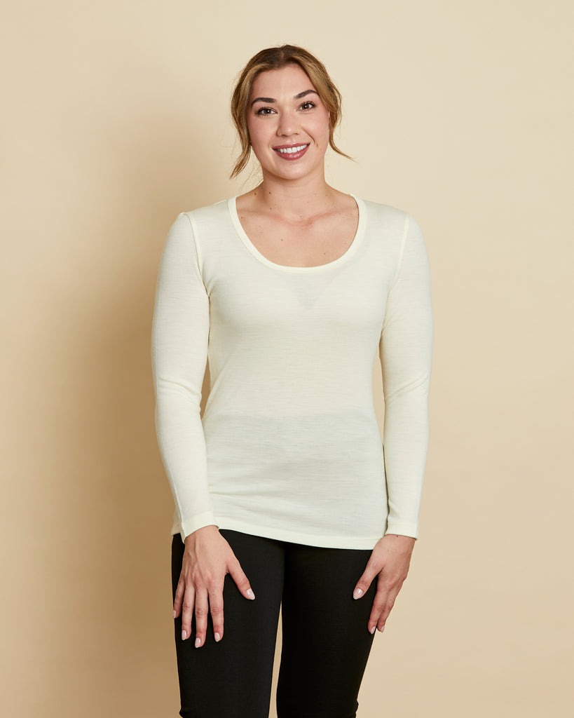 Woman wearing soft Australian Merino wool long sleeve scoop neck in natural. Designed to wear next to the skin as a base layer or on its own as a t.shirt style, it is perfect for layering! Made in Australia at Woolerina workrooms at Forbes in central west NSW.