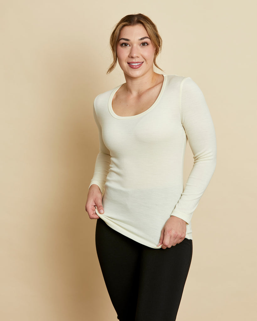 Woman wearing soft Australian Merino wool long sleeve scoop neck in natural. Designed to wear next to the skin as a base layer or on its own as a t.shirt style, it is perfect for layering! Made in Australia at Woolerina workrooms at Forbes in central west NSW.