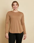 Woman wearing soft Australian Merino wool crew neck pullover in camel. Relaxed fitting, designed to wear over other layers as an outer layer or on its own next to the skin. Made in Australia at Woolerina's workrooms at Forbes in central west NSW.
