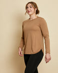 Woman wearing soft Australian Merino wool crew neck pullover in camel. Relaxed fitting, designed to wear over other layers as an outer layer or on its own next to the skin. Made in Australia at Woolerina's workrooms at Forbes in central west NSW.