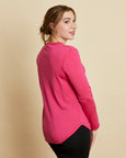 Woman wearing soft Australian Merino wool crew neck pullover in hot pink. Relaxed fitting, designed to wear over other layers as an outer layer or on its own next to the skin. Made in Australia at Woolerina's workrooms at Forbes in central west NSW.