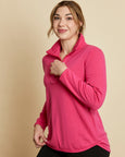 Woman wearing a soft Australian Merino wool pullover with a quarter zip in hot pink. Relaxed fitting, designed to wear over other layers as an outer layer or on its own next to the skin. Made in Australia at Woolerina's workroom at Forbes in central west NSW.