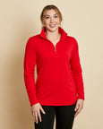 Woman wearing a soft Australian Merino wool pullover with a quarter zip in tomato red. Relaxed fitting, designed to wear over other layers as an outer layer or on its own next to the skin. Made in Australia at Woolerina's workroom at Forbes in central west NSW.