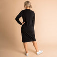 Woman wearing soft Australian Merino wool relaxed fitting long sleeve crew neck dress in black. Designed as a relaxed fit and sitting around knee length. This style is perfect as a base to add other layers. Made in Australia at Woolerina's workrooms at Forbes in central west NSW.