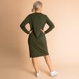 Woman wearing soft Australian Merino wool relaxed fitting long sleeve crew neck dress in hunter green. Designed as a relaxed fit and sitting around knee length. This style is perfect as a base to add other layers. Made in Australia at Woolerina's workrooms at Forbes in central west NSW.
