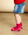 Child wearing pink Australian merino wool socks made by Humphrey Law in Melbourne VIC.